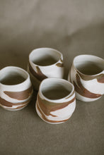 Load image into Gallery viewer, Four white and brown tumblers on a beige fabric background. These pieces are made from white Australian stoneware clay with brown and white marbled clay inlaid during the wheel throwing process.