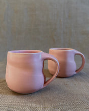 Load image into Gallery viewer, Two pink ceramic mugs on a textured beige surface