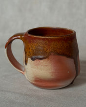 Load image into Gallery viewer, Woodfired ceramic mug with dark red crystal glaze on a linen background